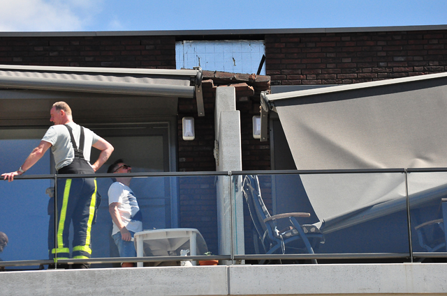 Groot zonnescherm breek af bij flat in Waalwijk: Vrouw heeft engeltje op haar schouder