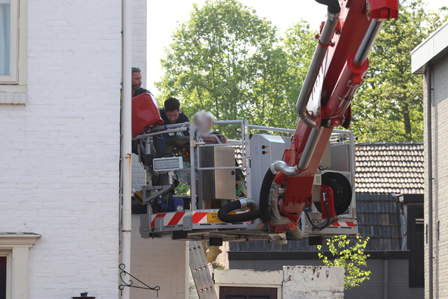 Hulpdiensten redden vrouw van dak naast woning aan de Meester van Coothstraat Waalwijk
