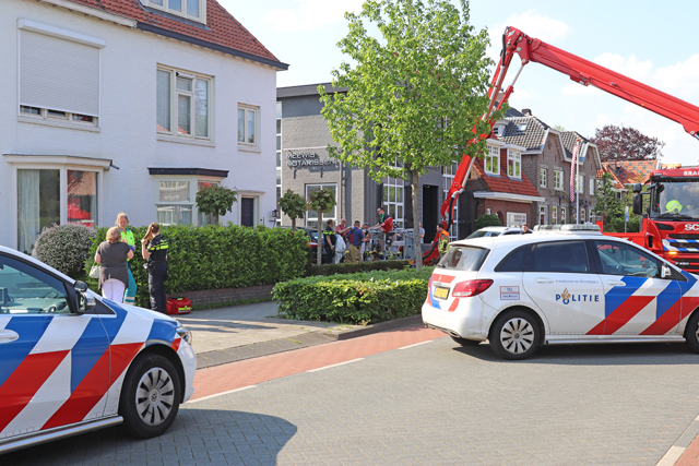 Hulpdiensten redden vrouw van dak naast woning aan de Meester van Coothstraat Waalwijk